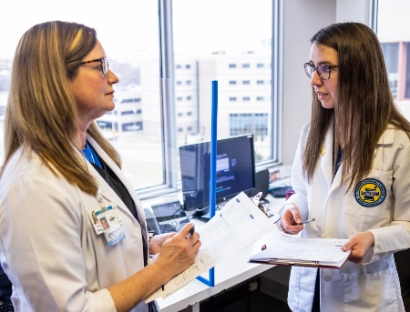 A pharmacy student and professor discuss patient care at the St. Luke's clinic in Kansas City.