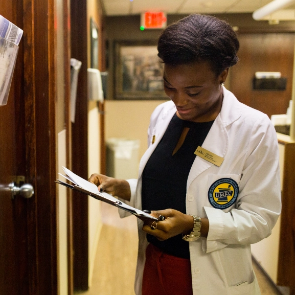A pharmacy graduate student review a patient chart while working at the St. Luke's clinic.