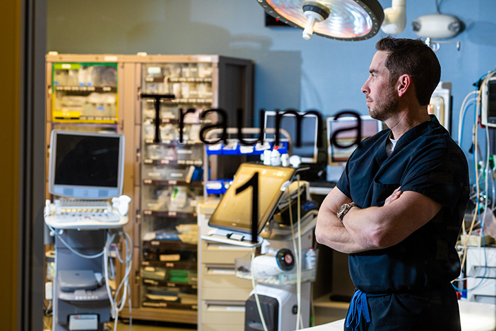 Portrait of Jeremy Hampton, School of Pharmacy graduate, in the trauma center where he works 