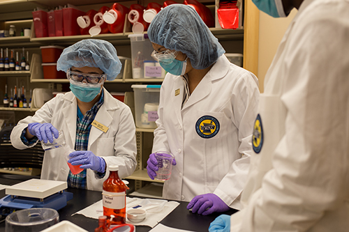 Students create a formula in the compounding lab during camp