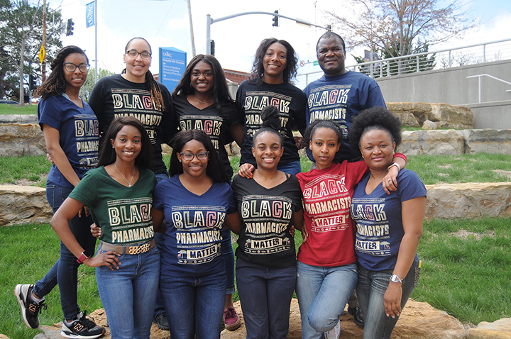 The founding members of the UMKC School of Pharmcy's Black Student Pharmacists group pose in front of the school